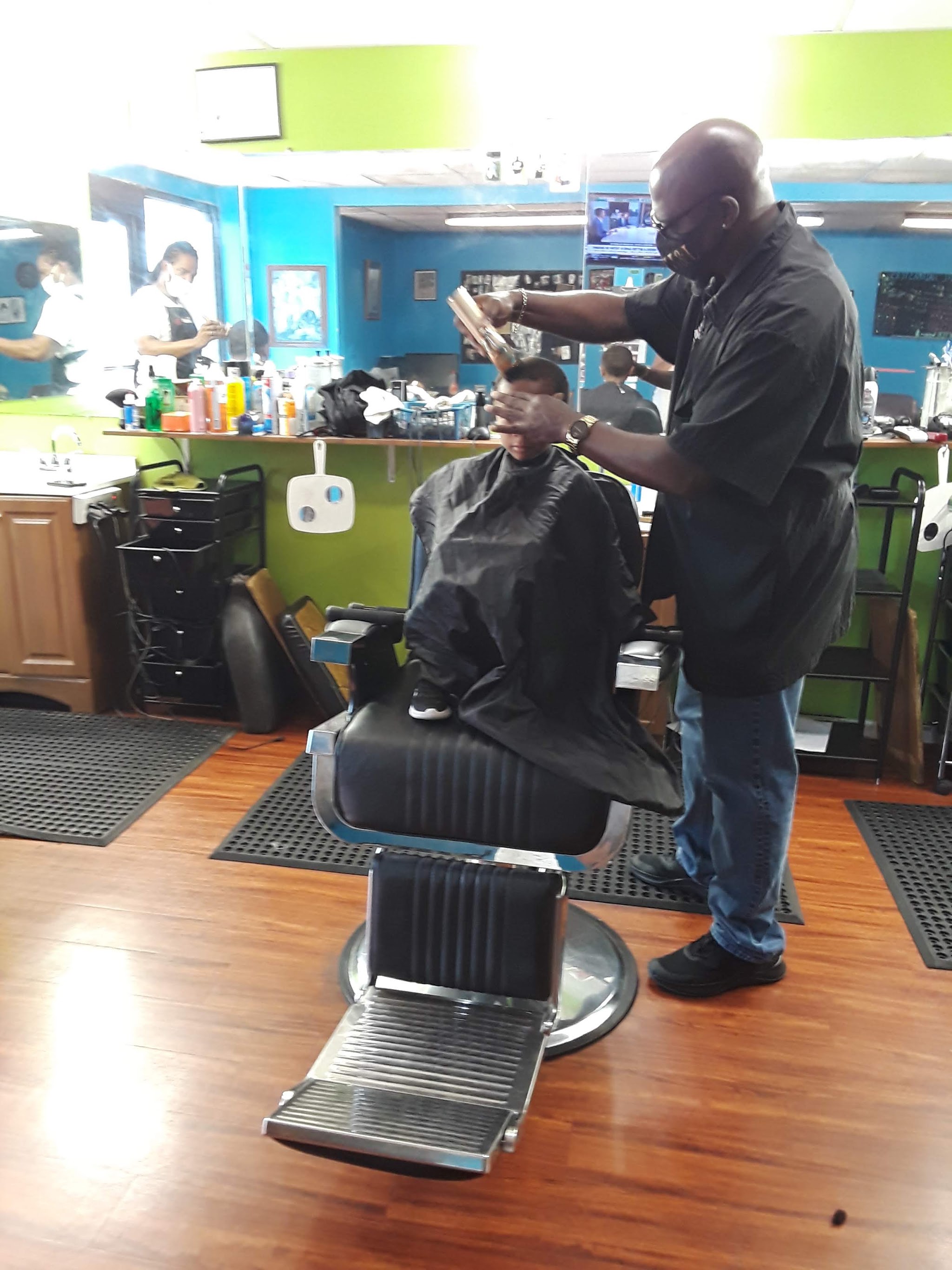 One of our barbers cutting a child's hair in the chair