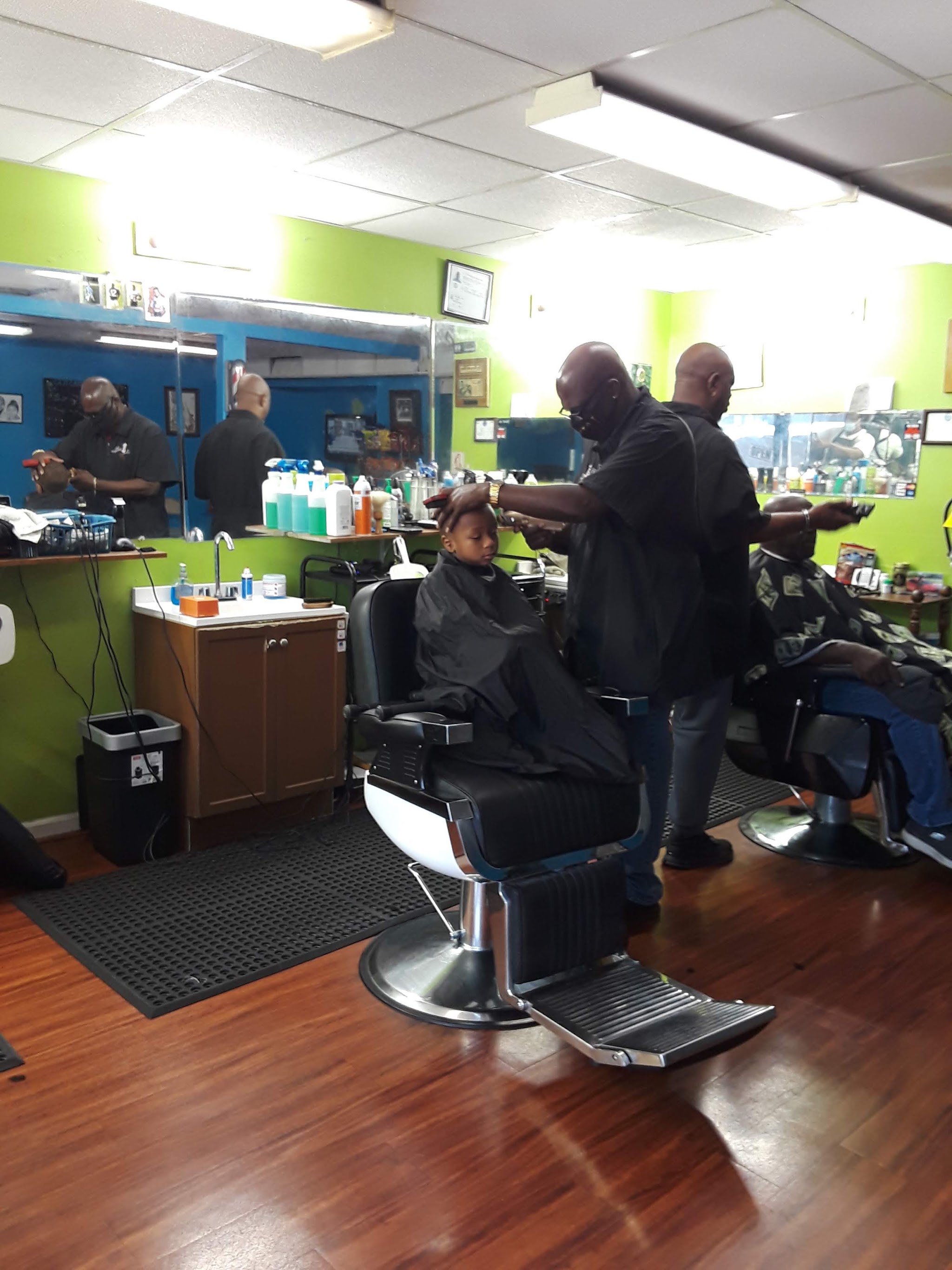 Two of our barbers cutting side by side